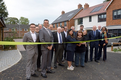 Councillors, members of our housing team, representatives from Life Build Solutions, Project Managers BPM Ltd and Architects Kyle Smart Associates and new tenants cutting the ribbon during a special ceremony