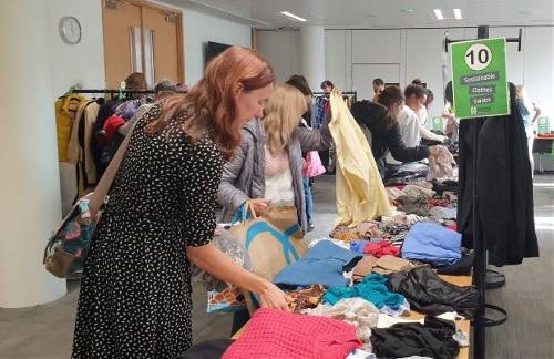Swappers browse through second-hand clothing at the October Sustainable Clothes Swap
