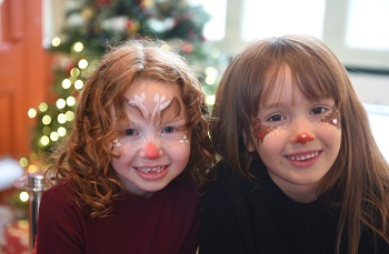 Two children with reindeer-themed face paint at the Old Town Christmas event